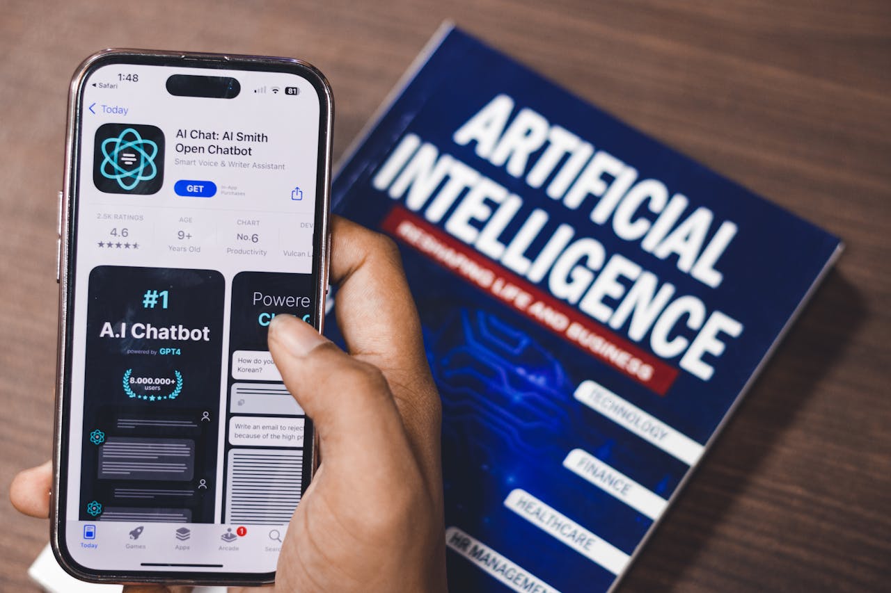get-in-touch Smartphone displaying AI app with book on AI technology in background.