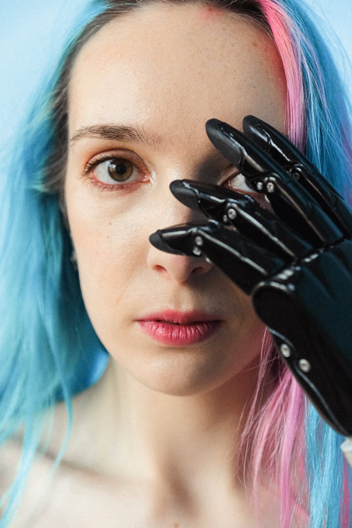 services-03 Close-up portrait of a woman with colored hair and a prosthetic hand